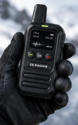 ZE Radio held in a gloved hand in the snow
